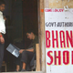 A foreign tourist reads the menu in a small wooden hut selling bhang in Jaisalmar,